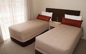 two single beds in the second room of 2-bedroom apartment